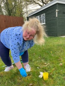 A person we support at Woodside Cottage & The Elms planting a tree for the jubilee